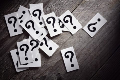 question marks spilling across a table